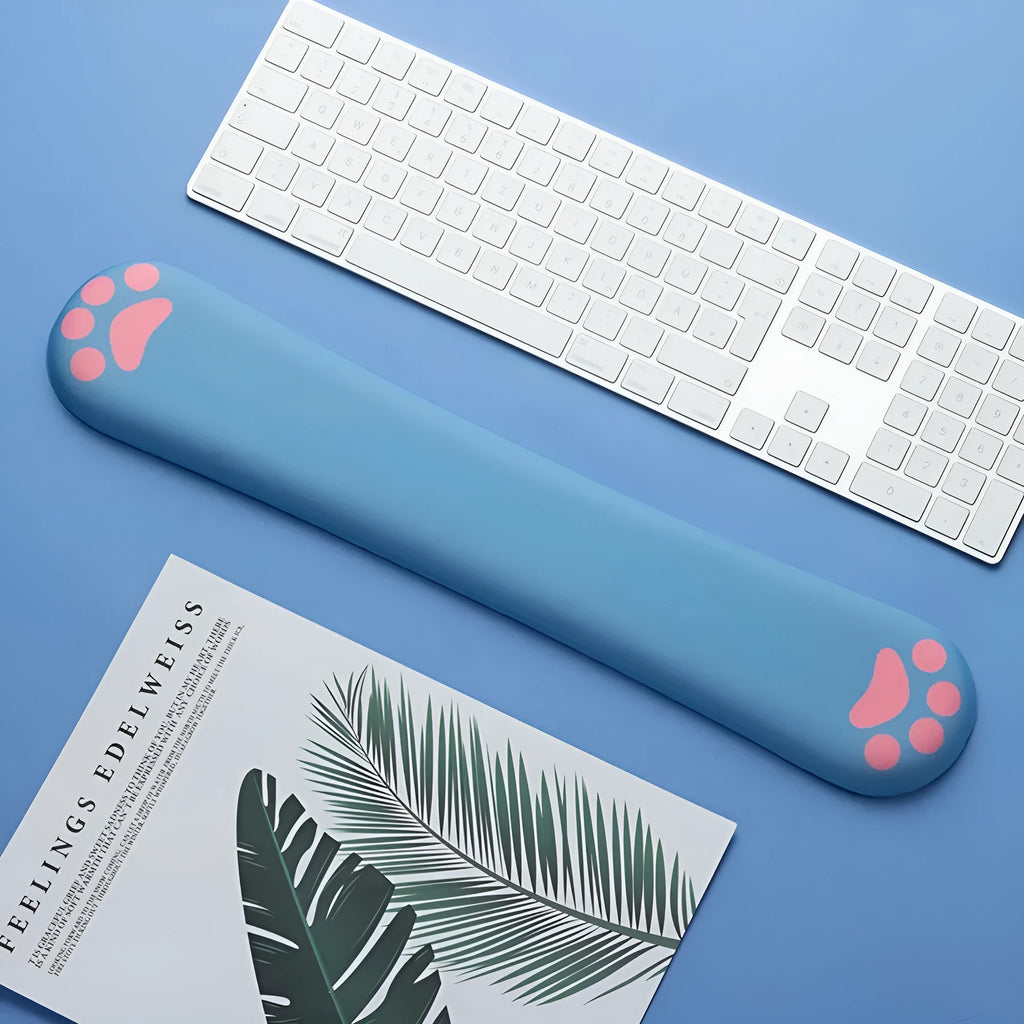 Cat's claw shaped memory foam wrist support pad in black, placed in front of a keyboard.