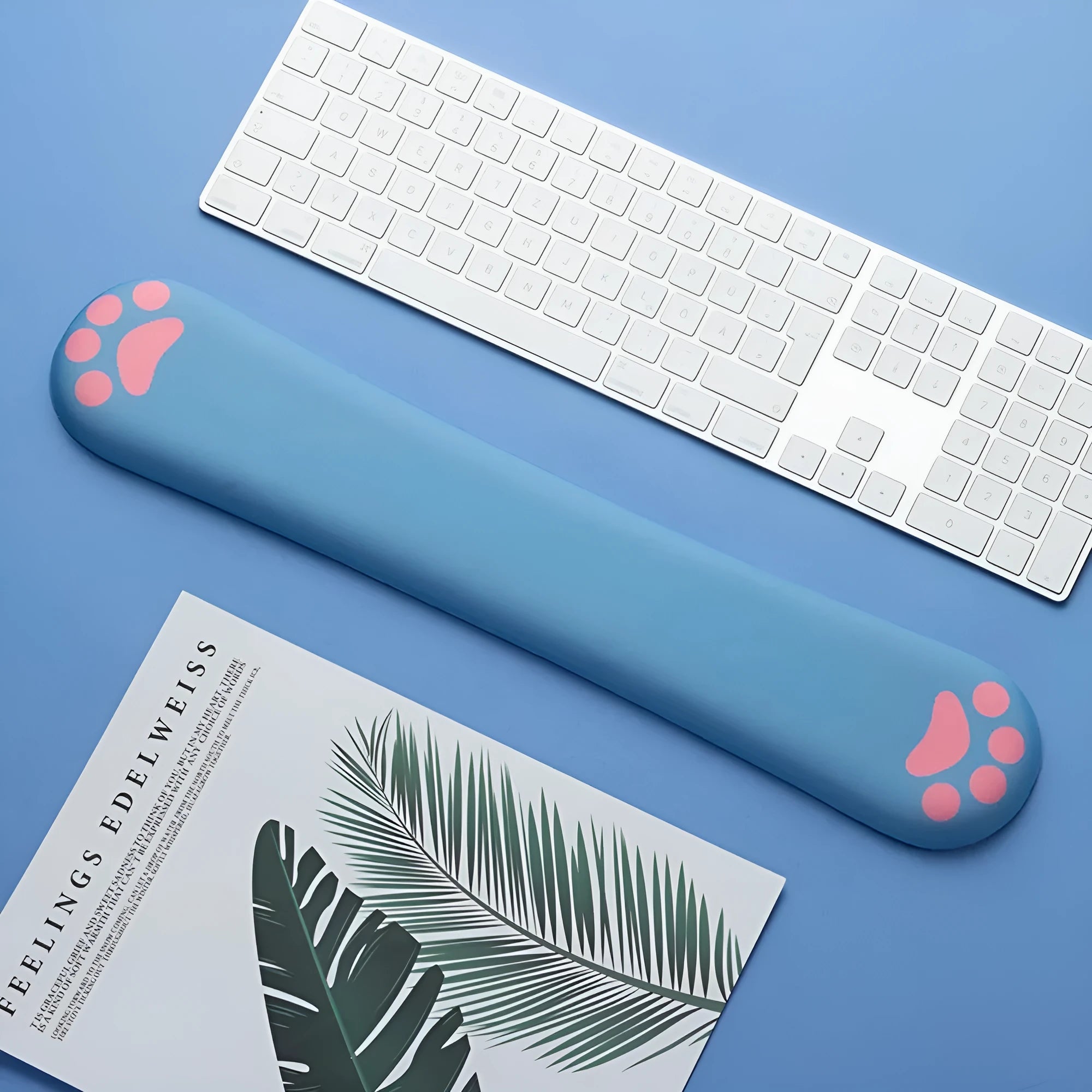 Cat's claw shaped memory foam wrist support pad in black, placed in front of a keyboard.