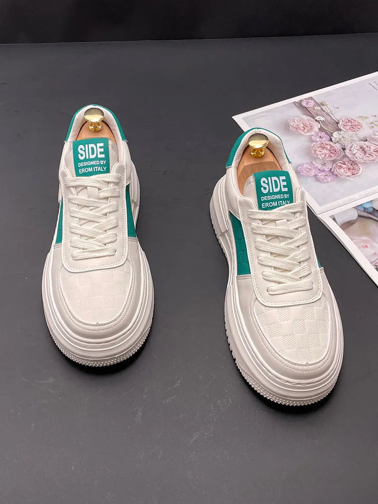 A pair of white, black, and green casual sports shoes with cloth uppers and rubber foam soles.