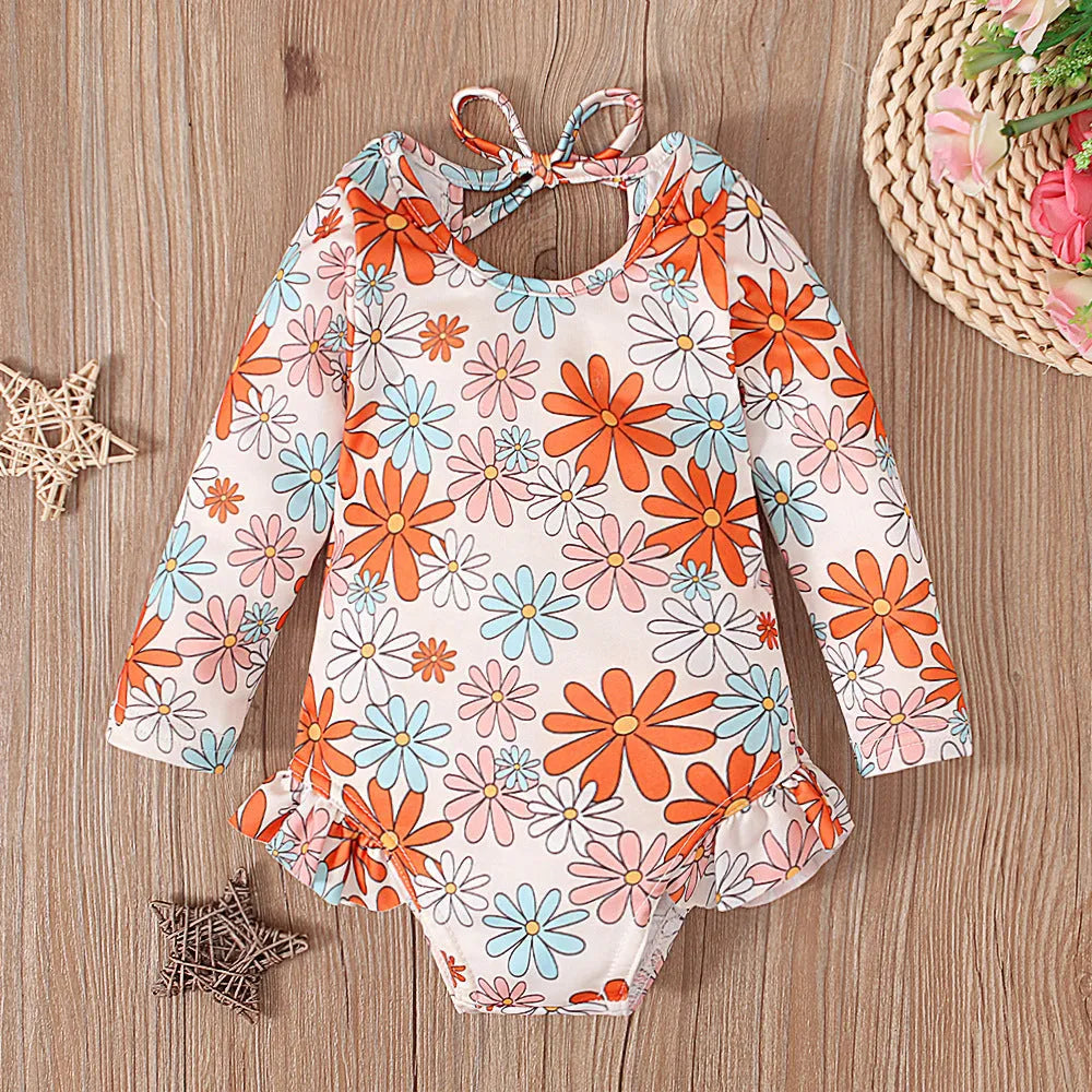 Girls floral print swimsuit with crew neck front and open back in orange colour