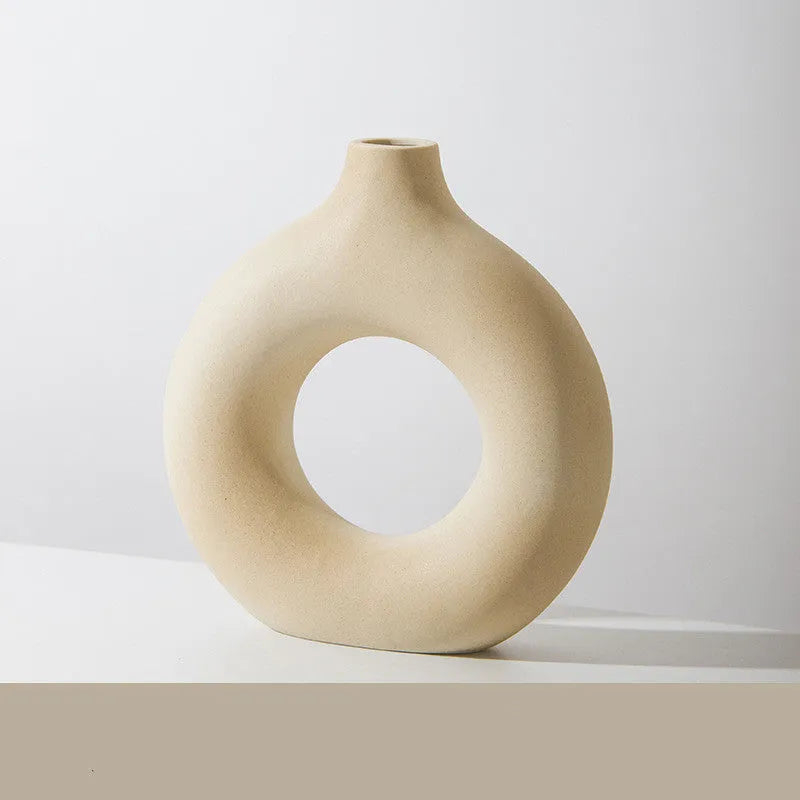 A simple modern frosted porcelain biscuit vase in a neutral colour, for flower arranging.