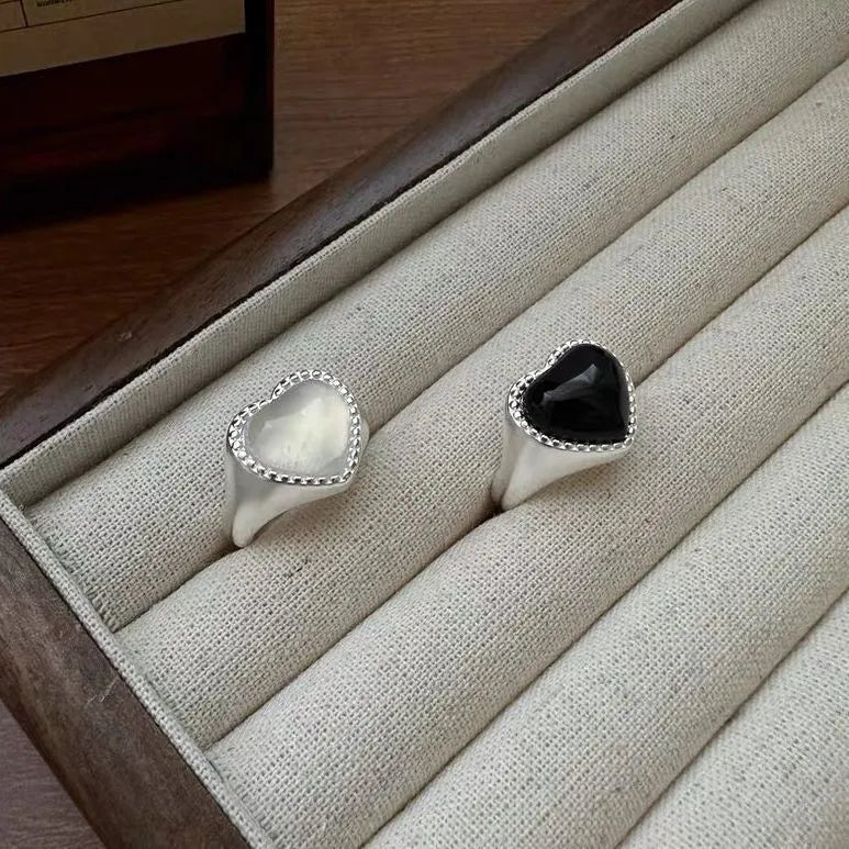 Black agate heart ring in sterling silver with an adjustable open mouth design.