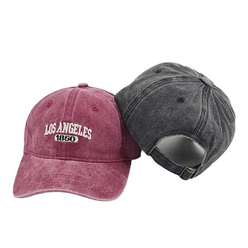 Distressed beige baseball cap with embroidered letters on the front, showing adjustable strap and curved 7cm peak.