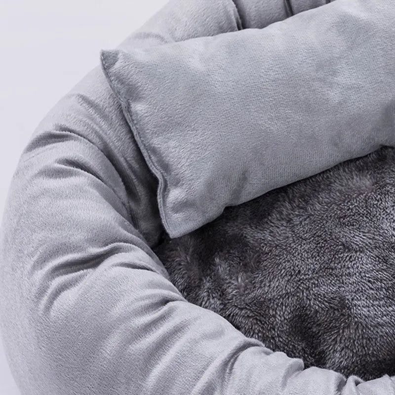Grey round plush pet bed with removable pillow and non-slip base in four size options