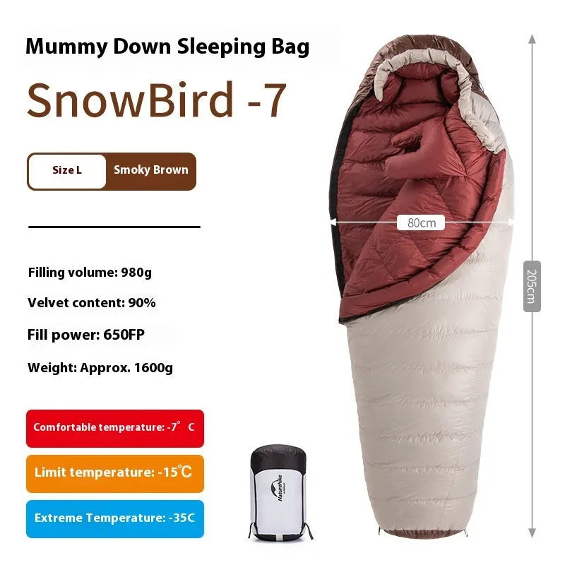 Adult mummy-style sleeping bag with goose down filling shown with its storage bag.