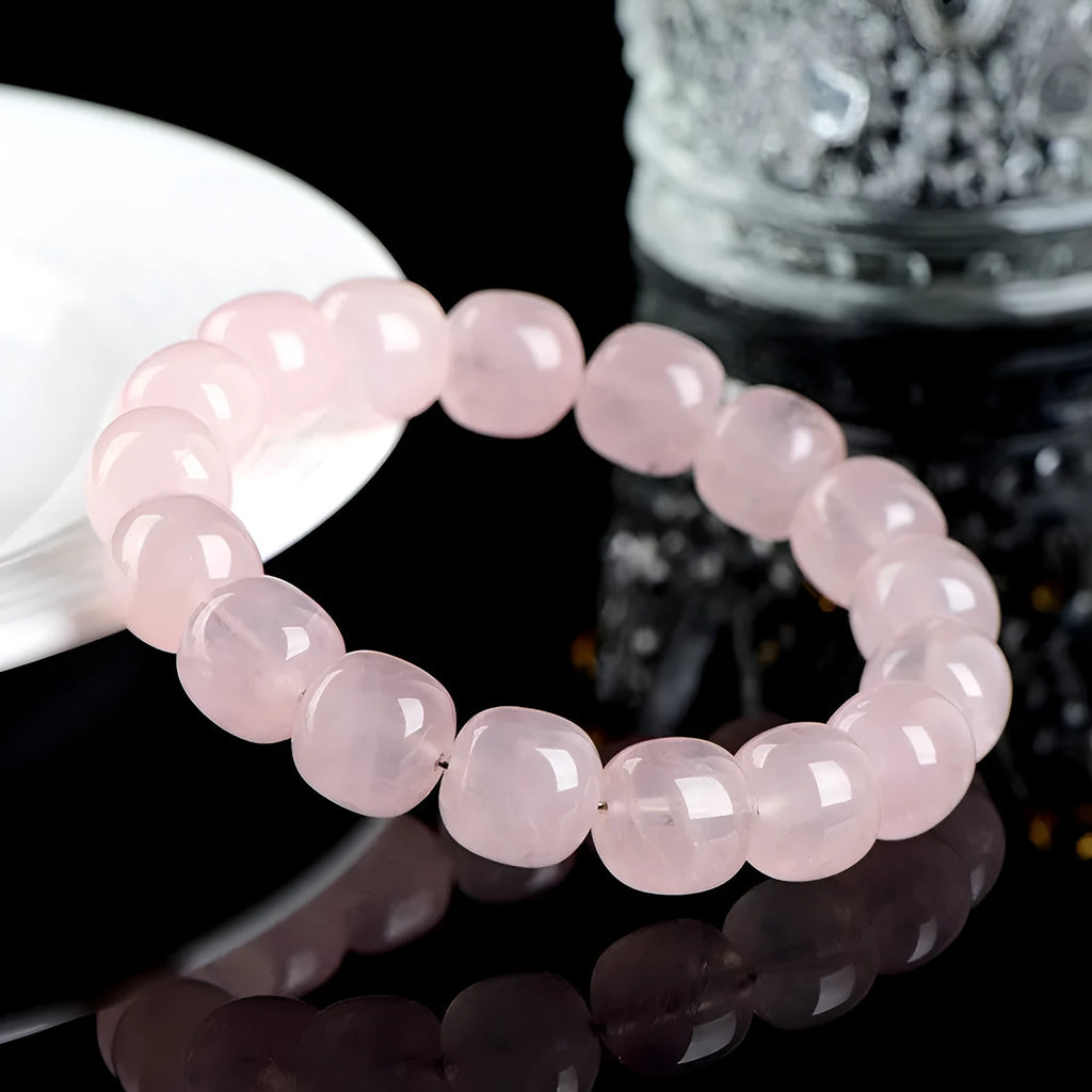 Pink crystal bamboo bracelet with 11x12mm geometric barrel beads on a wrist.