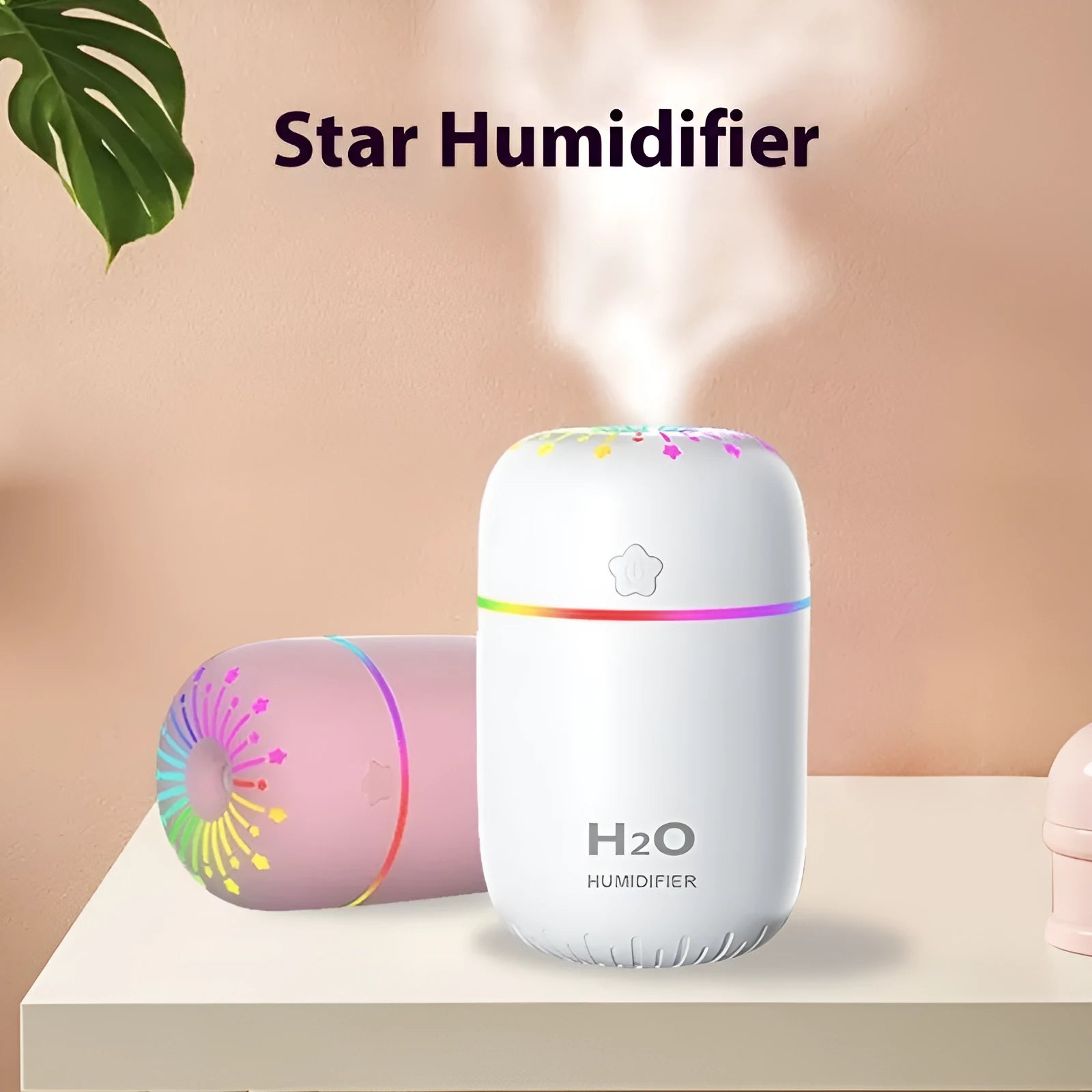 White USB portable mini humidifier with water tank on desk beside laptop