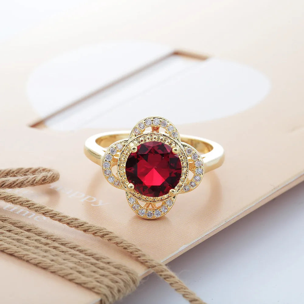 Copper ring with a fruit-shaped setting holding a zircon stone.