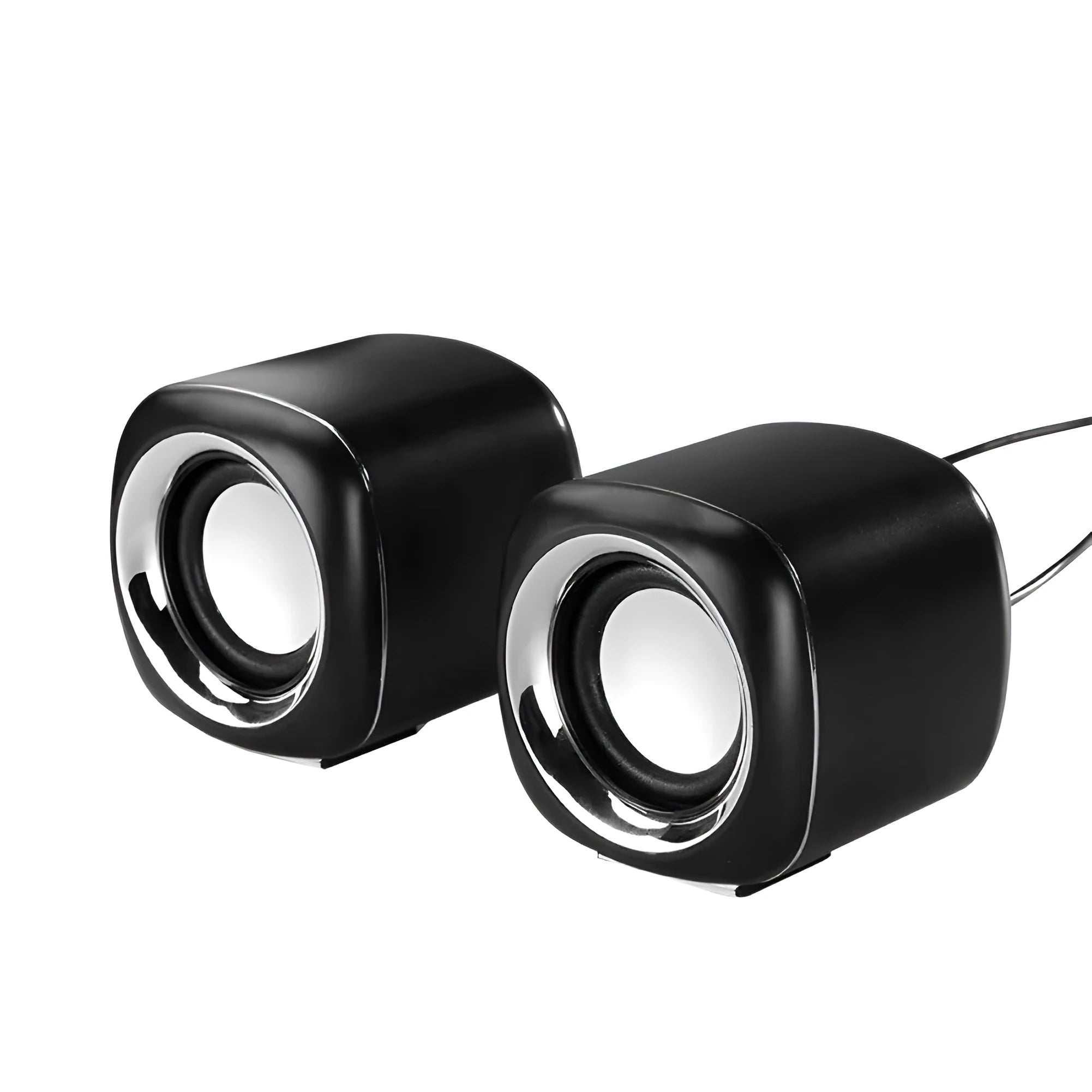 A pair of small black wired computer speakers with a volume scroll wheel, shown next to a 3.5mm audio plug on a desk.