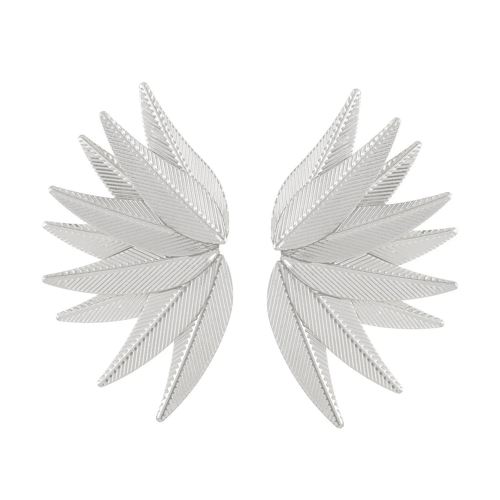 Gold and white alloy leaf-shaped patch earrings on a plain background