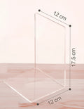 Clear transparent acrylic bookshelf holding a small stack of books on a desk.