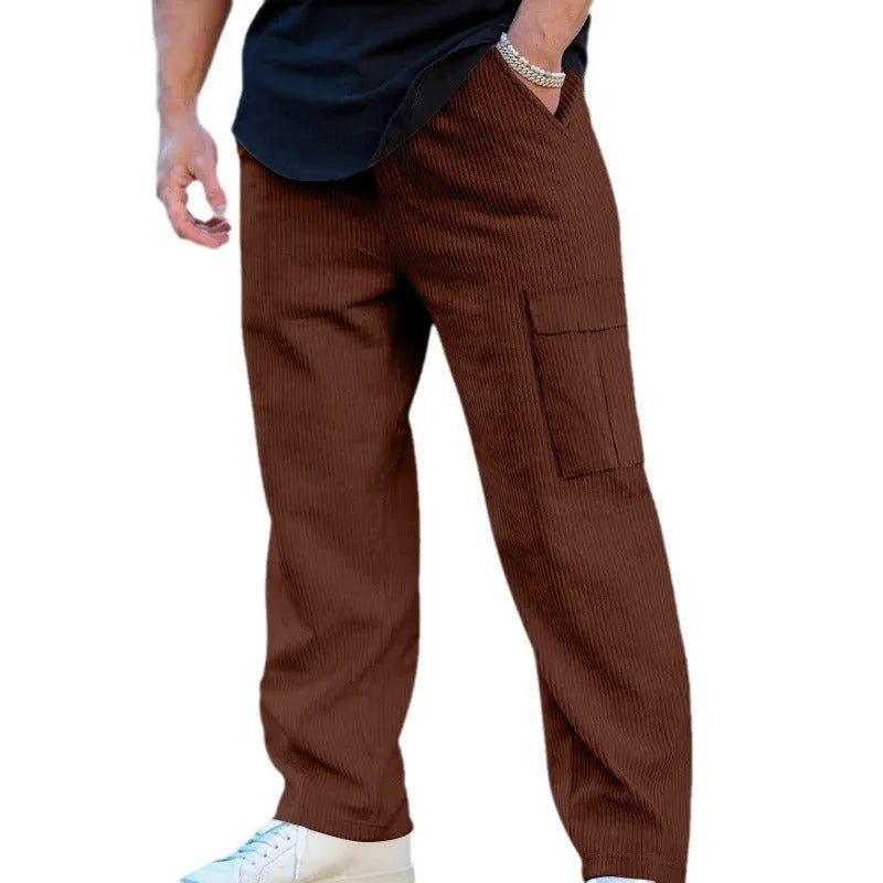 Men's navy blue corduroy cargo trousers with a drawstring waist and straight wide-leg cut on a hanger.