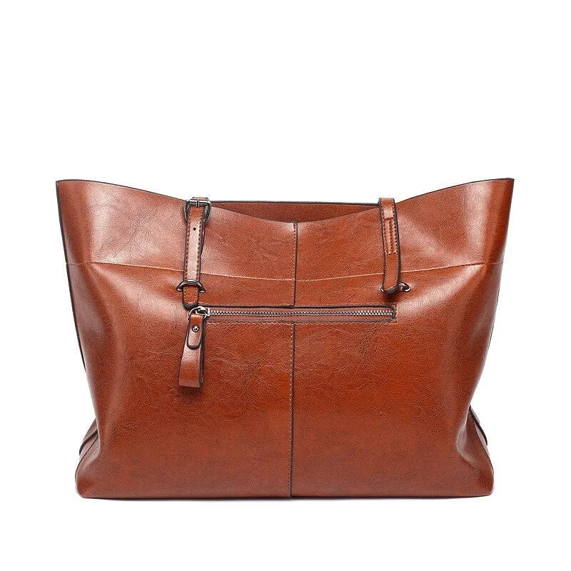 Brown waxed cowhide cross-body handbag showing front view, internal phone pocket, and adjustable leather strap.