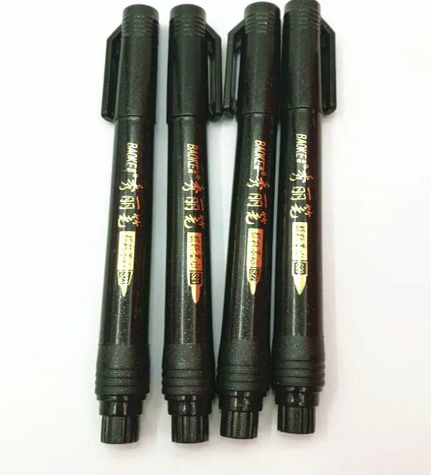 Set of 4 black calligraphy felt tip pens with ink refill bottles on a white surface