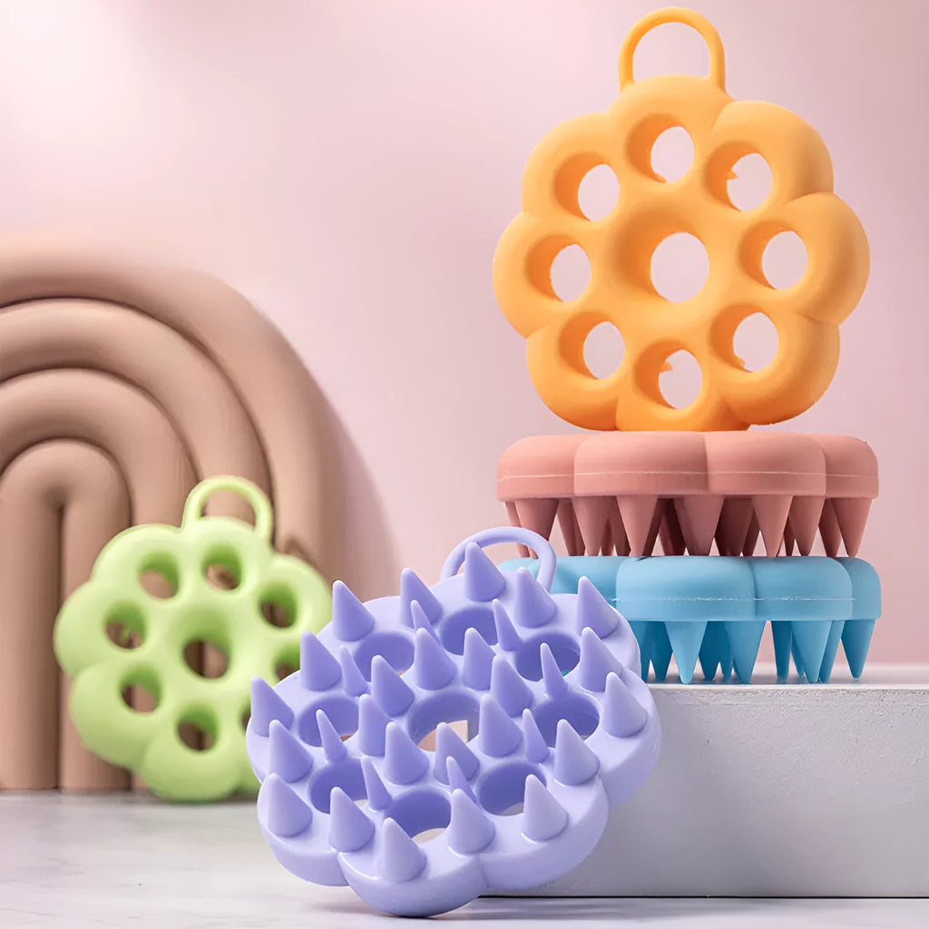 Silicone pet grooming brush with ergonomic handle shown in blue, for use on dog or cat coat during dry grooming or bath.