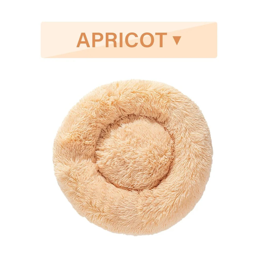 Fluffy donut-shaped pet bed in long plush fabric, showing raised rim, available in multiple colours.