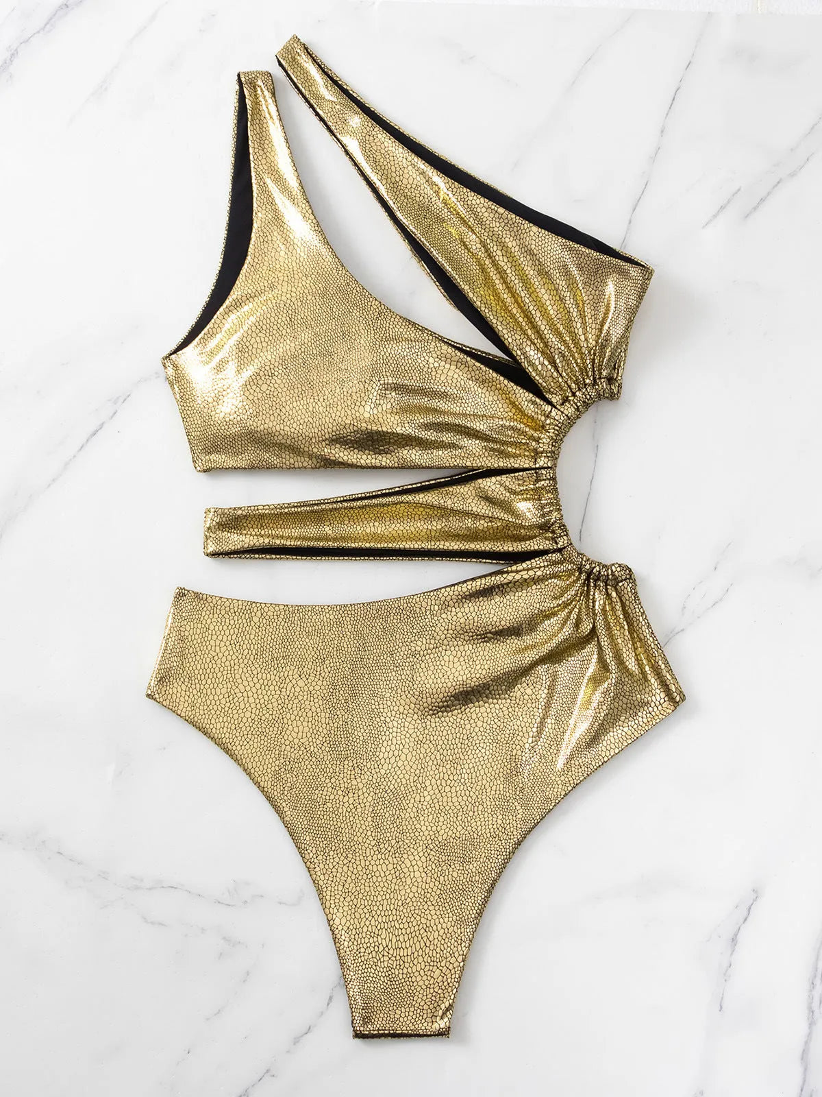 Women's gold backless one-piece swimsuit with spandex material on mannequin
