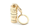 Gold-coloured zinc alloy mini LED flashlight on a keyring for outdoor and emergency use.