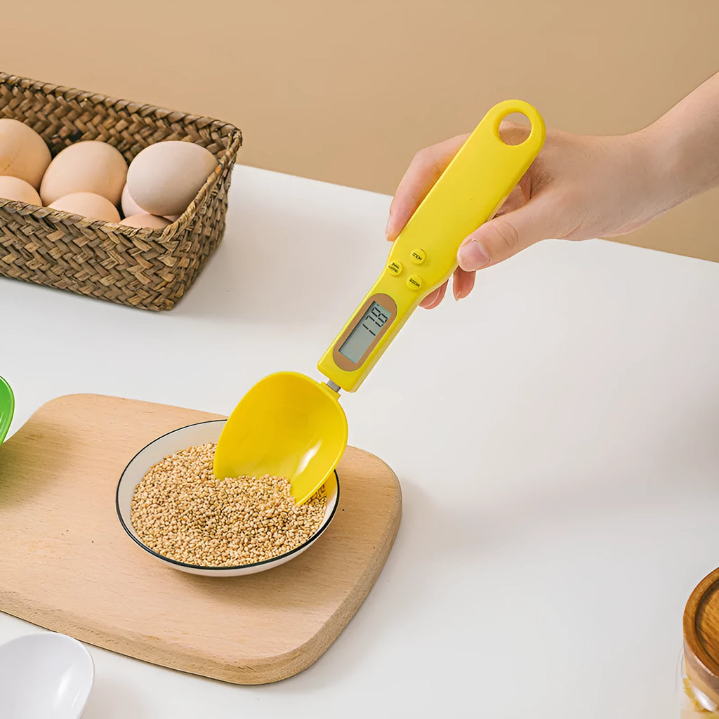 White digital kitchen spoon scale with LCD display showing weight measurement