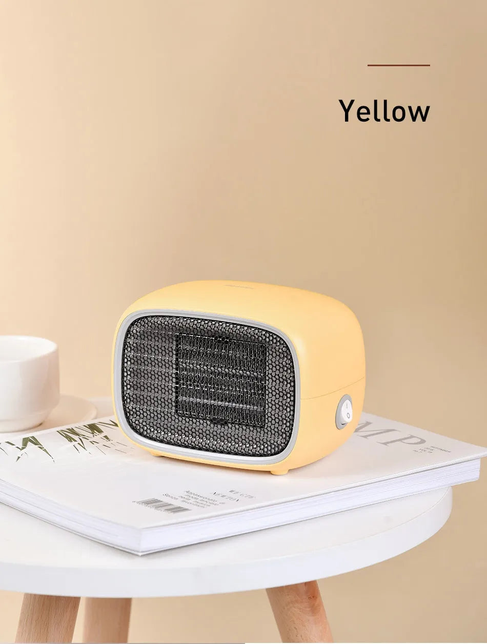 Green mini portable heater with dimensions 158mm x 90mm x 114mm on a wooden desk.