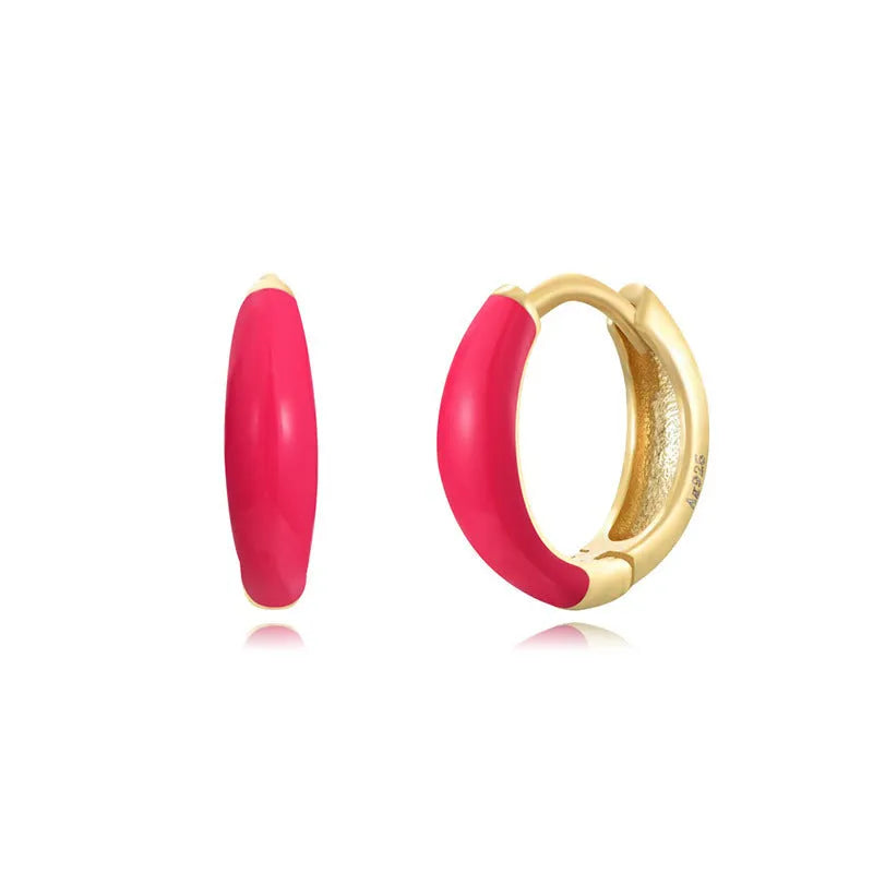 A pair of curved U-shaped epoxy earrings with a translucent blue dripped oil finish and a silver hook on a white background.