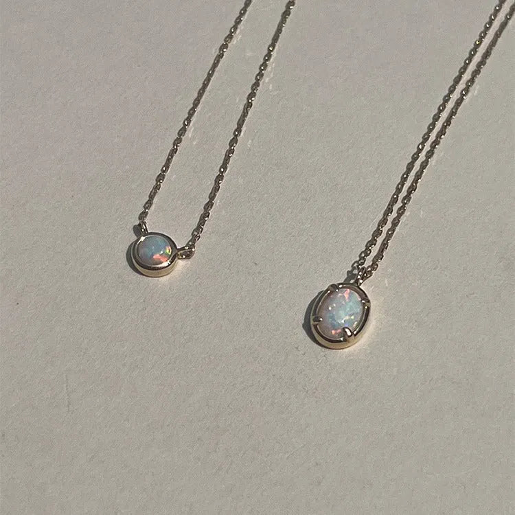Oval jelly opal geometric pendant on a sterling silver chain with gold plating.