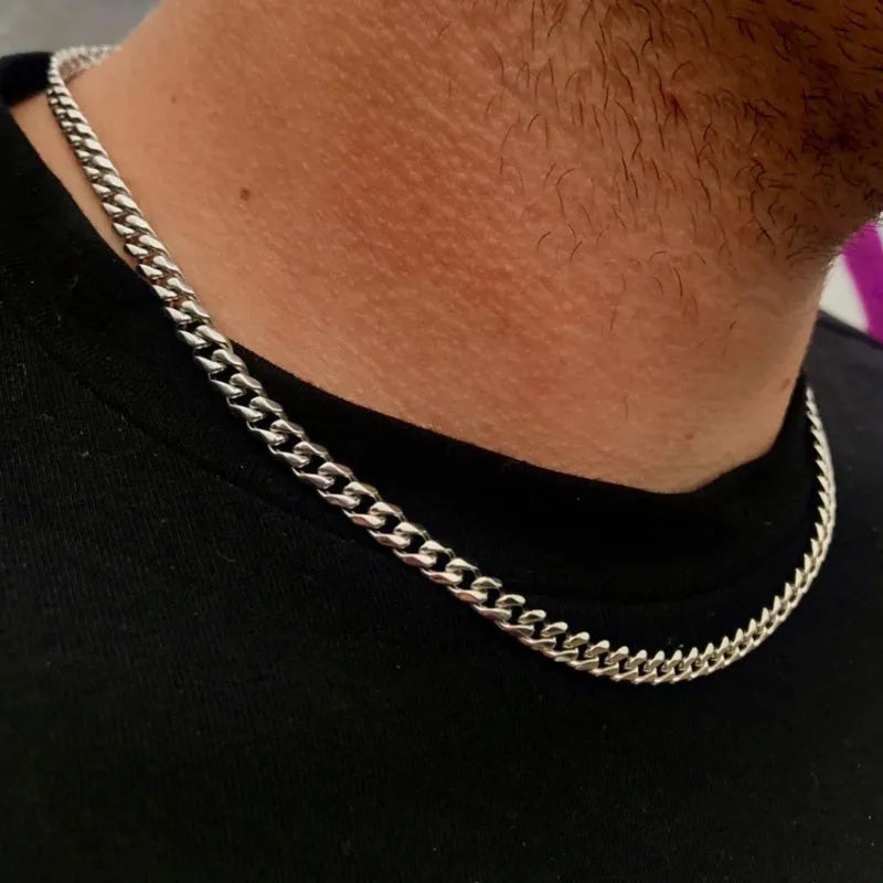 Less steel Figaro Cuban chain necklace in silver on white background showing links and clasp