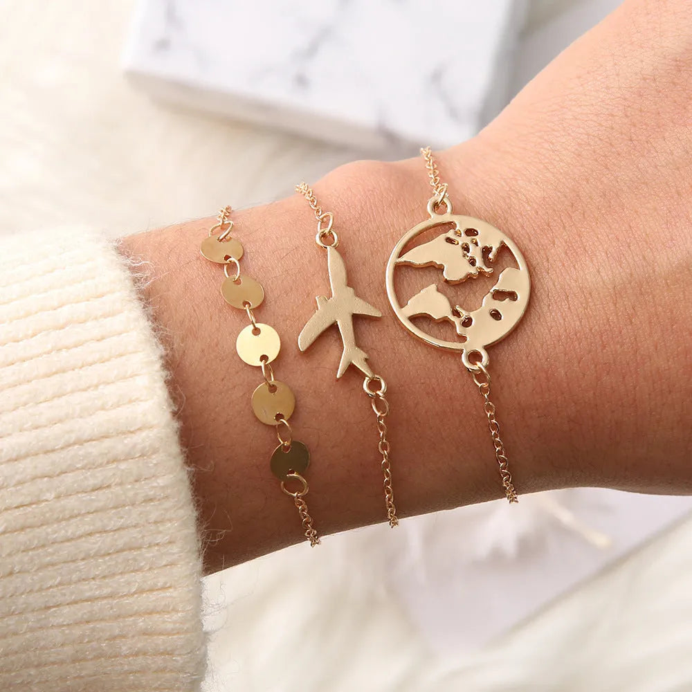 Set of three women's bohemian bracelets with heart-shaped aircraft map charms in alloy.