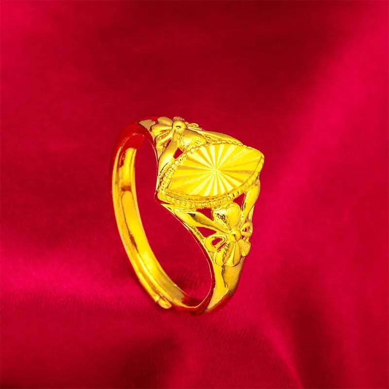Adjustable gold-coloured brass floral ring with openwork design and textured diamond details.