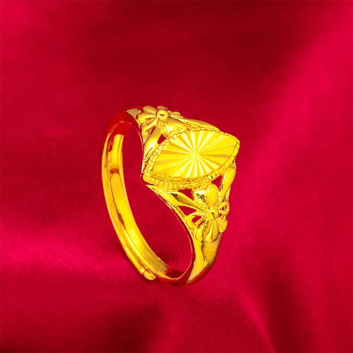 Adjustable gold-coloured brass floral ring with openwork design and textured diamond details.