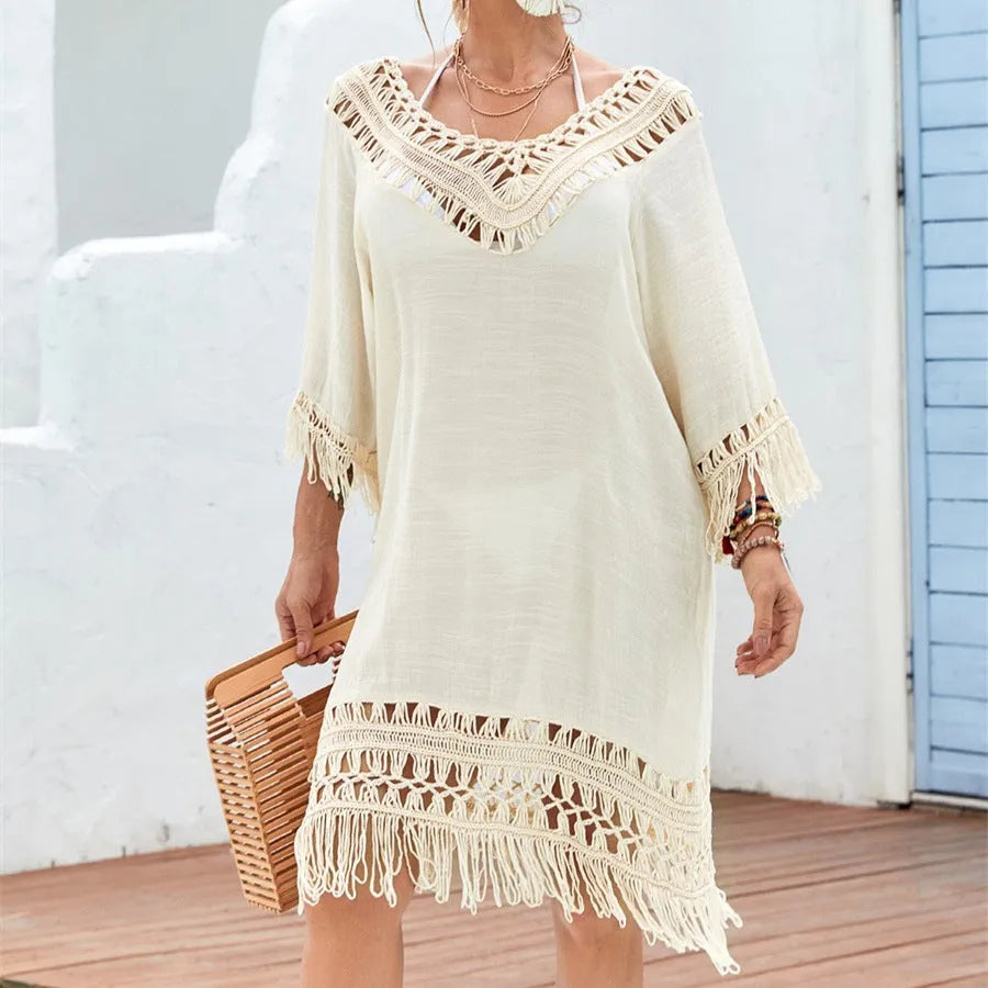 Apricot crocheted patchwork dress on a hanger showing regular sleeves and midi length.