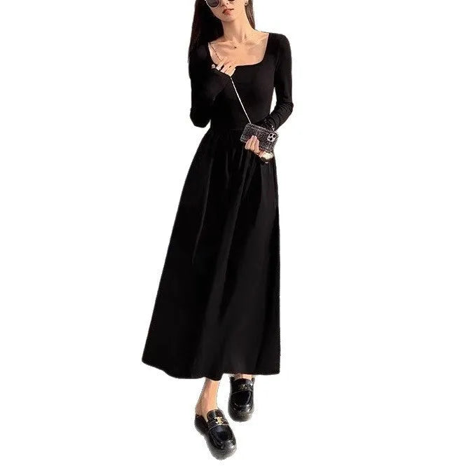 Women's black knitted dress with square collar, long sleeves, and an elastic A-line skirt.