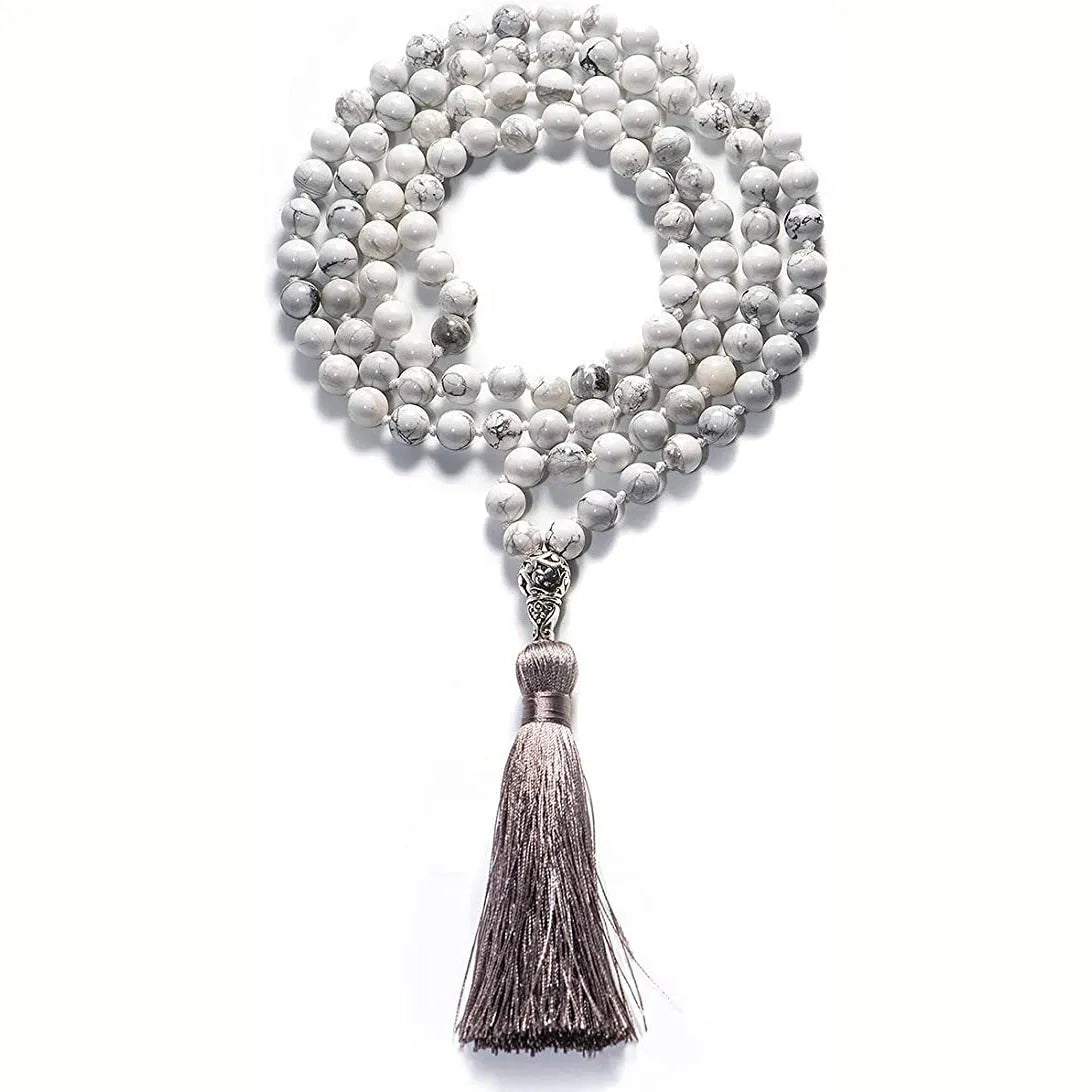 Long geometric agate tassel necklace with multi-coloured stones on a white background.