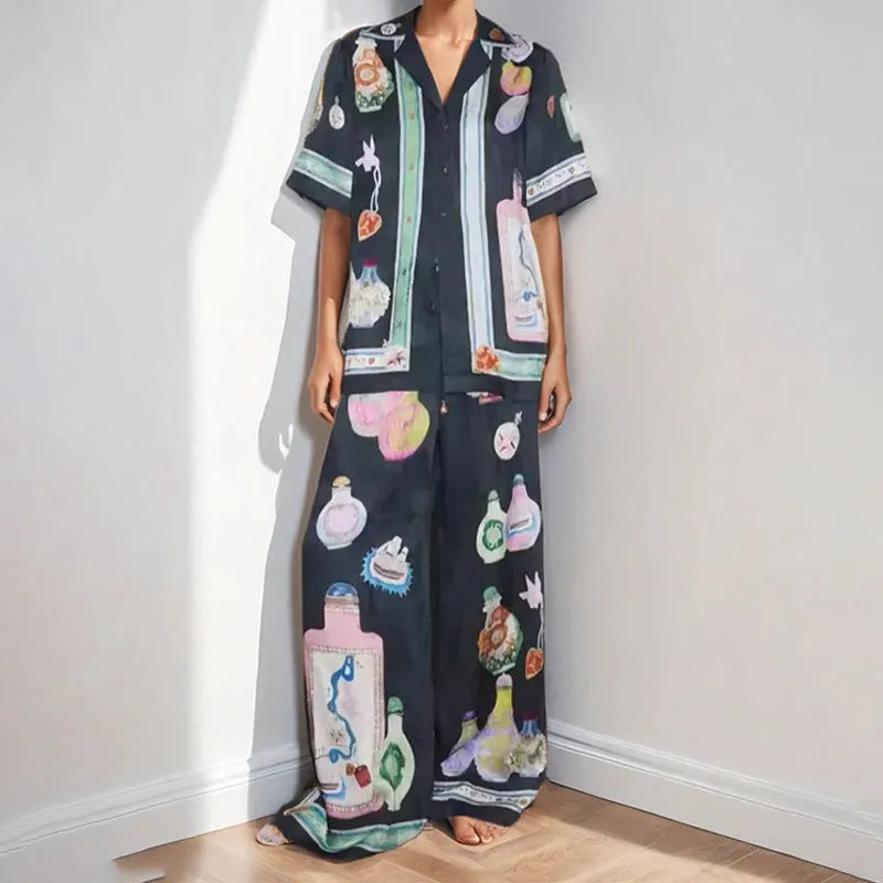 Black women's cardigan and trouser set with cartoon animation print.