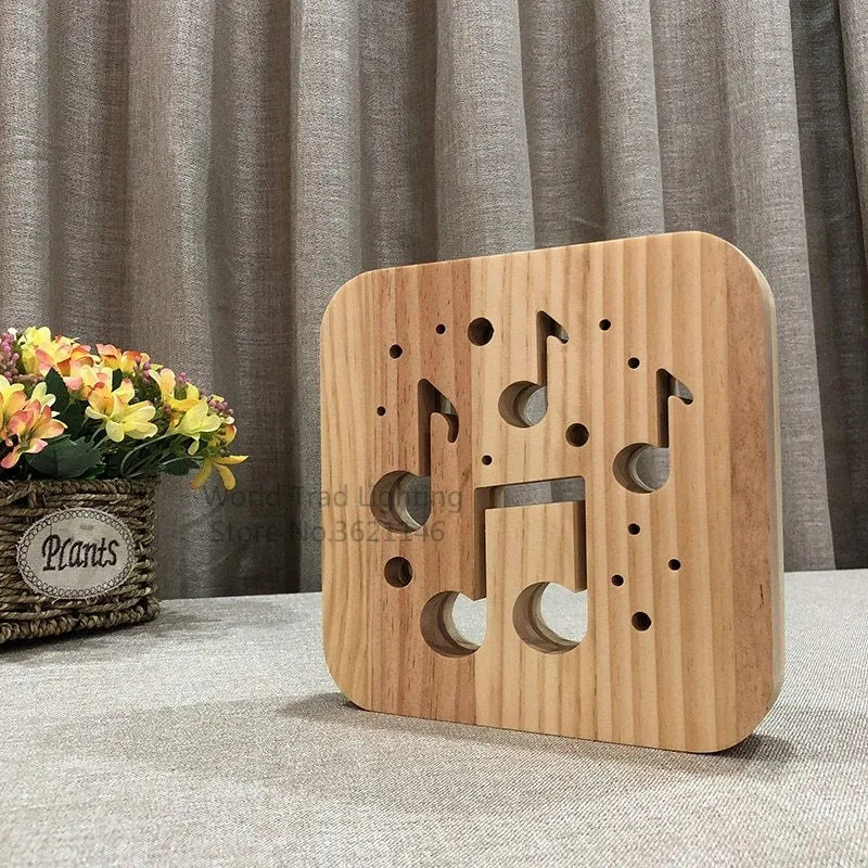 Solid pine wood cube USB atmosphere lamp glowing with warm white LED light on a wooden surface.