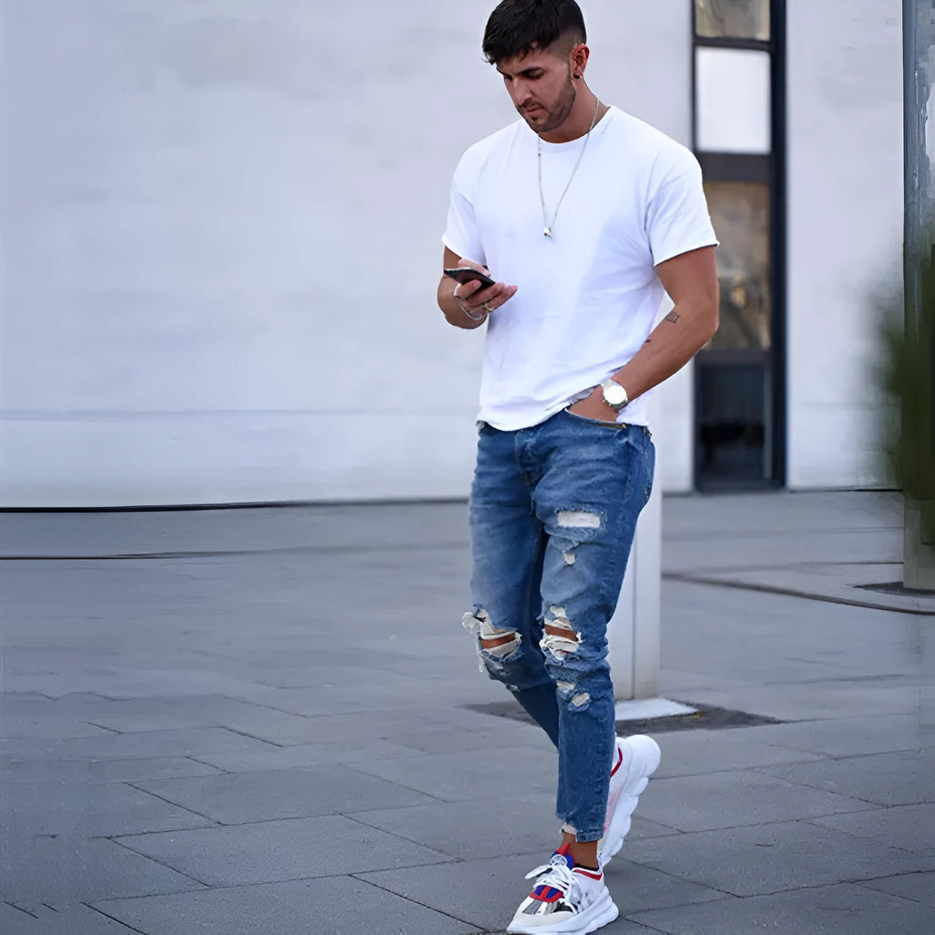 Men's distressed blue jeans with hole detailing in cotton fabric