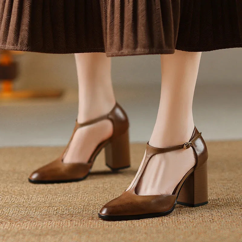 Women's pink and dark brown retro Mary Jane shoes with a pointed toe, buckle, and hollow design detail.