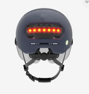 Adult cycling helmet with integrated red LED brake light and tail light on the rear.