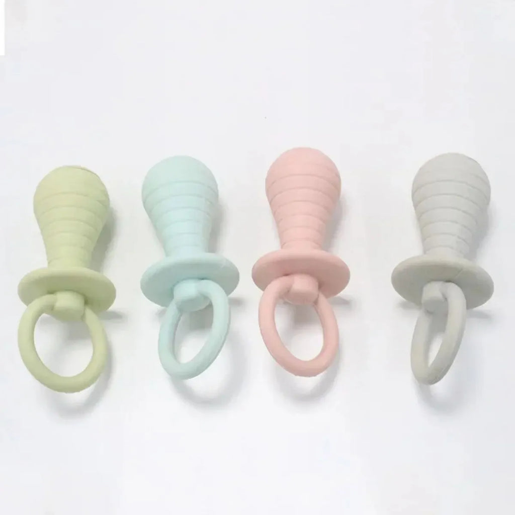 Four coloured TPR rubber pacifier-style pet chew toys with squeakers for puppies and kittens.