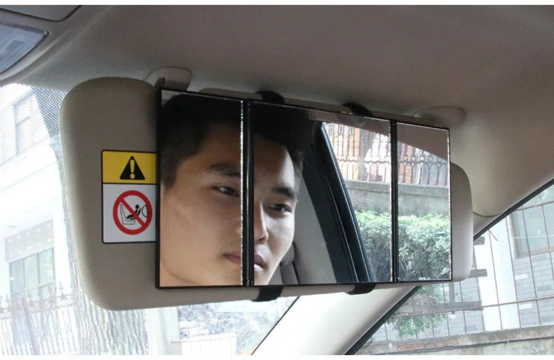 Silver folding car makeup mirror shown both closed and open on a car dashboard.