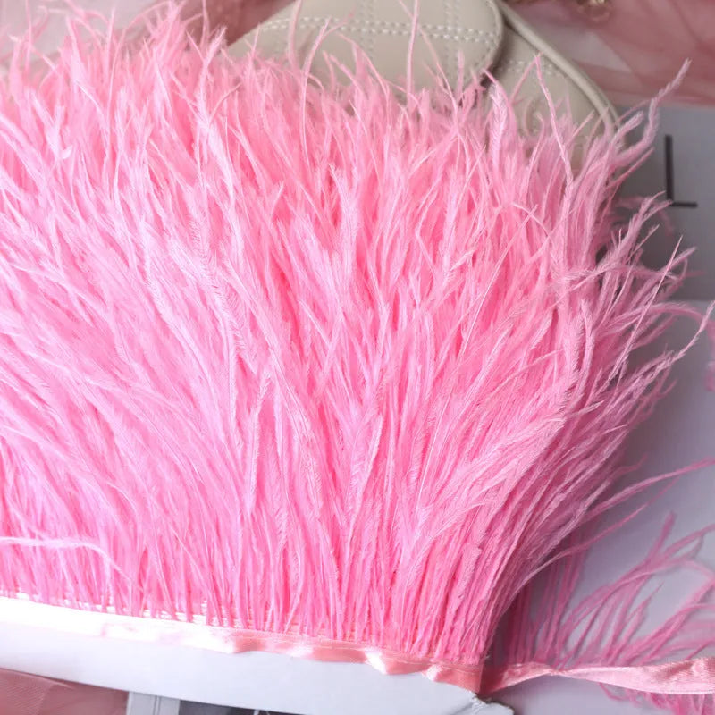 Decorative feather cloth strip in multiple colours including white, black, and mint green for DIY clothing and craft projects