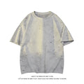Men's blue loose fit cotton blend T-shirt with ripped detail on short sleeve, laid flat.