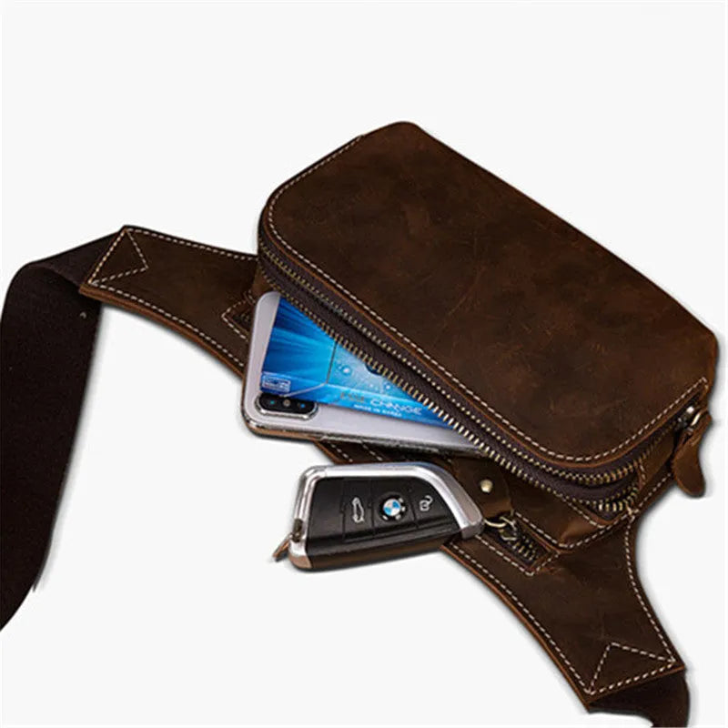 Brown top layer cowhide men's waist bag with pull cord closure, shown with a 10-inch laptop and mobile phone.