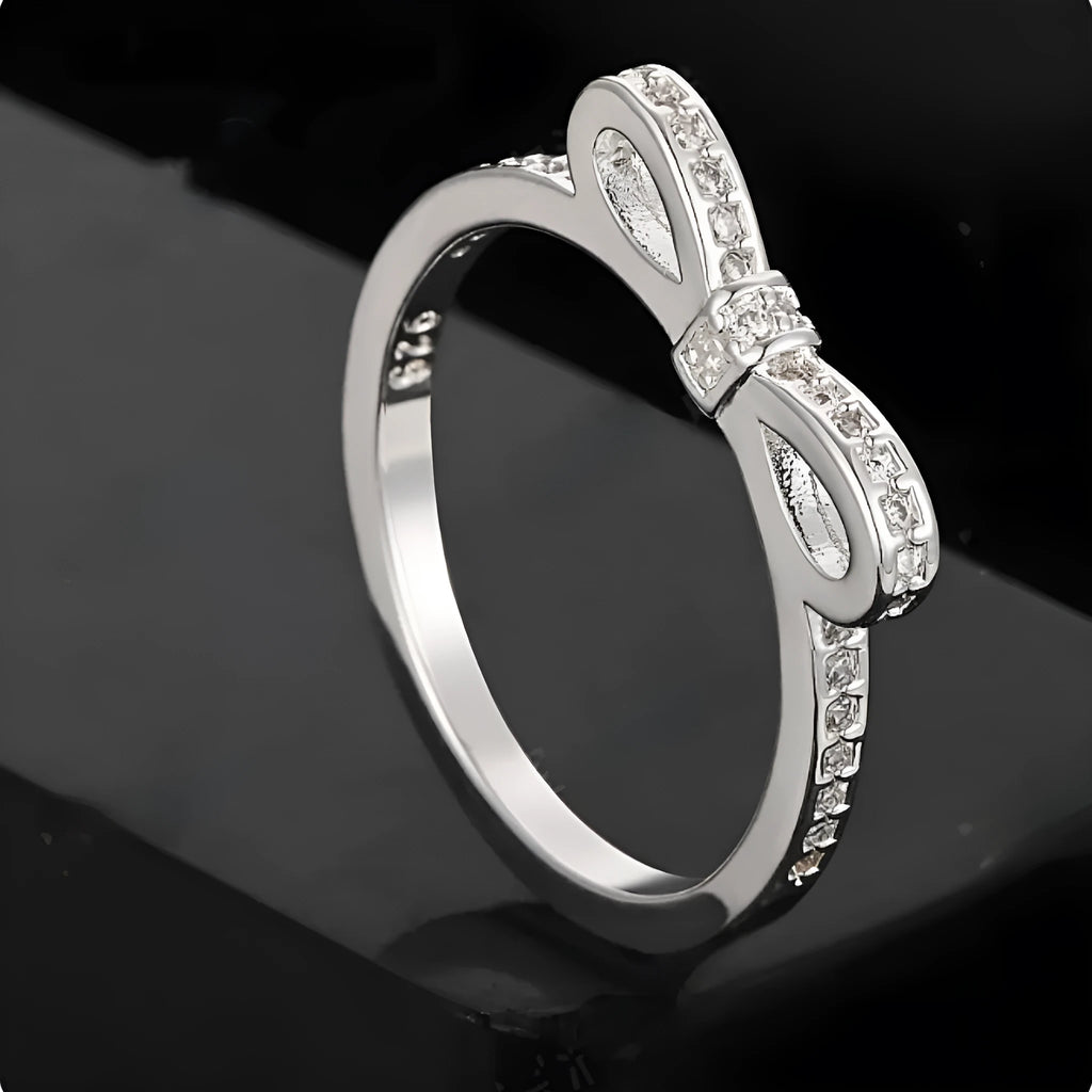 Silver plated fashion ring featuring a detailed 3D bow design set with sparkling zircon crystals on a plain band.
