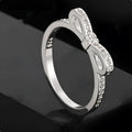 Silver plated fashion ring featuring a detailed 3D bow design set with sparkling zircon crystals on a plain band.