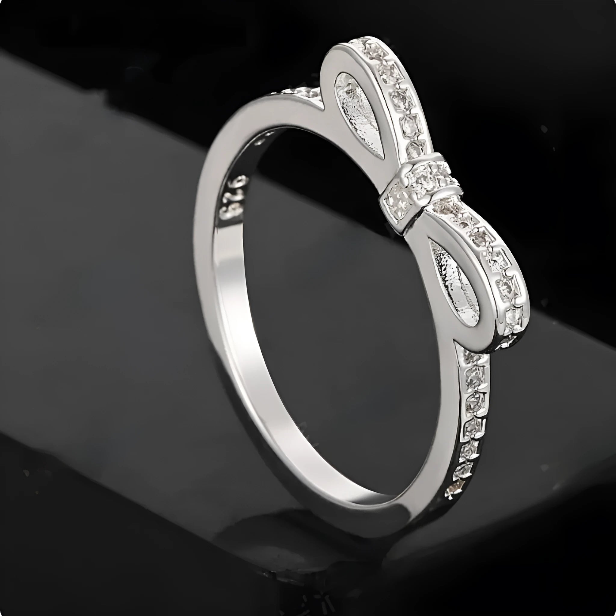 Silver plated fashion ring featuring a detailed 3D bow design set with sparkling zircon crystals on a plain band.