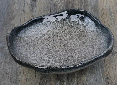 Japanese-style irregular coarse pottery sashimi bowl with floral decoration on glaze