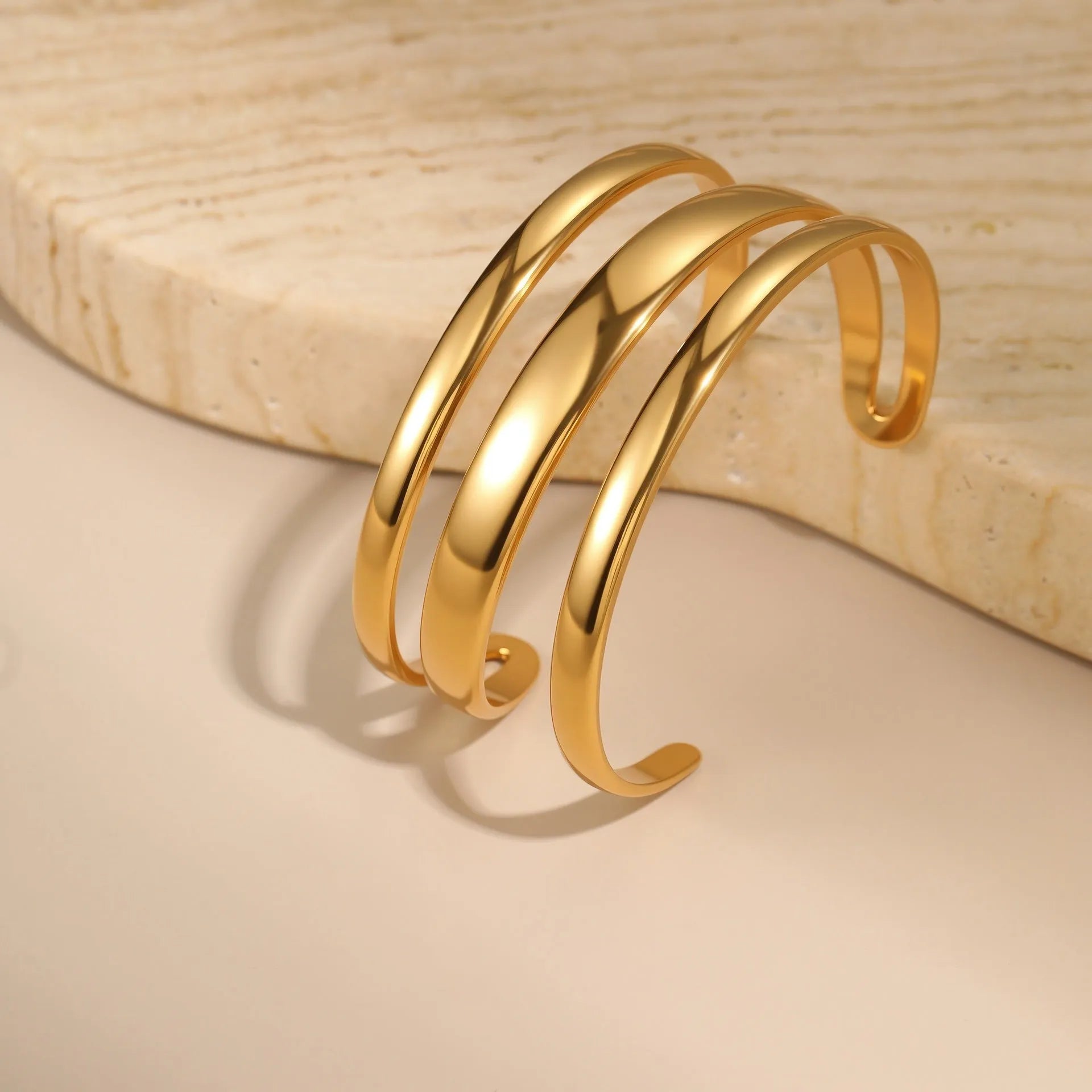 Women's stainless steel bracelet with geometric design and simple opening mechanism in gold electroplated finish