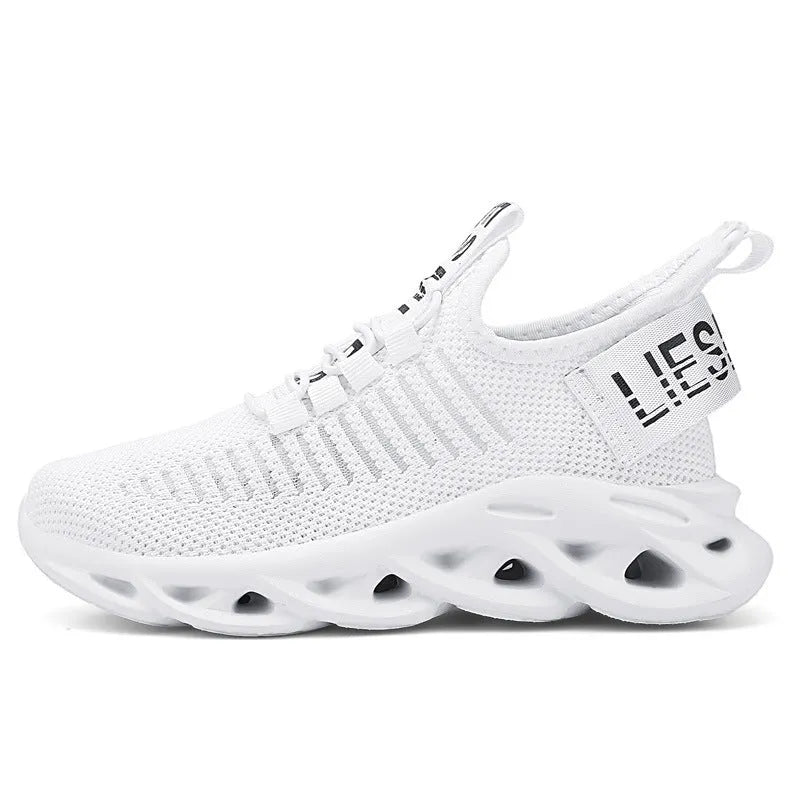 Children's black velcro sneakers with fabric upper and EVA sole on white background