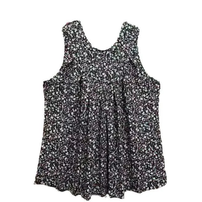 Plus size woman wearing a loose-fit black floral print sleeveless vest, showcasing the round neckline and textured collage stitching detail.